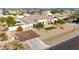 Single-story home featuring a tiled roof and a manicured lawn with mature landscaping and concrete driveway at 3911 N 197Th Ave, Buckeye, AZ 85396