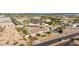 A high aerial of a desert home, showing a generous backyard and surrounding neighborhood at 3911 N 197Th Ave, Buckeye, AZ 85396
