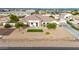 Well-kept single-story home boasting a tiled roof and a meticulously maintained yard with green turf at 3911 N 197Th Ave, Buckeye, AZ 85396
