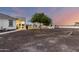 Large backyard features a covered patio, outdoor bar area, desert landscaping and large shade tree at 3911 N 197Th Ave, Buckeye, AZ 85396