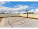 An outdoor basketball court with a hoop for recreational fun in this backyard at 3911 N 197Th Ave, Buckeye, AZ 85396