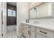 Bathroom featuring a white vanity with black hardware and decorative tile flooring at 3911 N 197Th Ave, Buckeye, AZ 85396