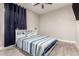 Relaxing bedroom featuring a striped bedspread and wood-look flooring at 3911 N 197Th Ave, Buckeye, AZ 85396