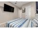 Cozy bedroom with light-colored walls, a ceiling fan, and wood-look floors at 3911 N 197Th Ave, Buckeye, AZ 85396