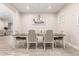 Dining room features a neutral color palette, wood flooring, and a modern chandelier at 3911 N 197Th Ave, Buckeye, AZ 85396