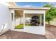 Covered outdoor dog run with black iron enclosure, white stucco walls, and artificial turf at 3911 N 197Th Ave, Buckeye, AZ 85396