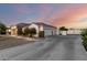 Single-story home with stone accents and a spacious driveway leading to a three-car garage at 3911 N 197Th Ave, Buckeye, AZ 85396