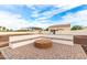 Cozy outdoor firepit area is surrounded by bench seating and paver stones at 3911 N 197Th Ave, Buckeye, AZ 85396
