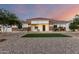 Charming single-story home featuring a decorative stone facade and tidy lawn with mature landscaping at 3911 N 197Th Ave, Buckeye, AZ 85396