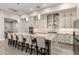 Large kitchen island with seating and stainless appliances with hanging pendant lights at 3911 N 197Th Ave, Buckeye, AZ 85396