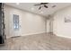 Bright, open living room with stylish tile flooring and a decorative glass front door at 3911 N 197Th Ave, Buckeye, AZ 85396