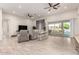 Open-concept living room featuring tile floors, recessed lighting, and a sliding glass door to the patio at 3911 N 197Th Ave, Buckeye, AZ 85396