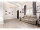 Inviting living room with stylish wood-look tile flooring, neutral walls, and ample natural light at 3911 N 197Th Ave, Buckeye, AZ 85396
