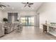 Open living room with wood-look flooring and sliding glass doors leading to the outdoor living space at 3911 N 197Th Ave, Buckeye, AZ 85396