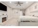 Bright main bedroom featuring wood floors, a fireplace, and a ceiling fan at 3911 N 197Th Ave, Buckeye, AZ 85396