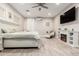 Spacious main bedroom featuring wood floors, fireplace, chaise lounge, and a ceiling fan at 3911 N 197Th Ave, Buckeye, AZ 85396