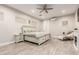 Spacious main bedroom featuring wood floors, a fireplace, and a ceiling fan at 3911 N 197Th Ave, Buckeye, AZ 85396