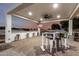 Covered outdoor bar area features bar stools, recessed lighting, and decorative flag at 3911 N 197Th Ave, Buckeye, AZ 85396