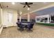 This covered outdoor patio features pavers, recessed lights, ceiling fan and glass-paneled door at 3911 N 197Th Ave, Buckeye, AZ 85396