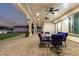 Covered outdoor patio features a dining table with chairs, ceiling fans and recessed lighting at 3911 N 197Th Ave, Buckeye, AZ 85396