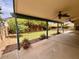 Inviting covered patio with ceiling fans overlooking a grassy backyard, perfect for outdoor enjoyment at 3932 E Tierra Buena E Ln, Phoenix, AZ 85032