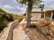 Landscaped backyard featuring a stone wall, lush plants, and a well-maintained walkway at 3932 E Tierra Buena E Ln, Phoenix, AZ 85032