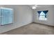 Secondary bedroom features natural light, neutral walls, and ceiling fan at 3932 E Tierra Buena E Ln, Phoenix, AZ 85032