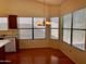 Bright dining area with wood floors, chandelier and multiple windows for natural light at 3932 E Tierra Buena E Ln, Phoenix, AZ 85032