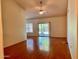 Open living room featuring wood flooring, a ceiling fan, and sliding doors to the backyard at 3932 E Tierra Buena E Ln, Phoenix, AZ 85032