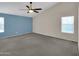 This main bedroom boasts a ceiling fan, neutral carpet, and a window at 3932 E Tierra Buena E Ln, Phoenix, AZ 85032