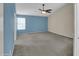 Spacious main bedroom features neutral carpet, a ceiling fan, and natural light at 3932 E Tierra Buena E Ln, Phoenix, AZ 85032
