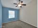 Neutral main bedroom features a ceiling fan and a large window at 3932 E Tierra Buena E Ln, Phoenix, AZ 85032