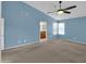 Spacious bedroom with blue wall, window, ceiling fan, and view to ensuite bathroom at 3932 E Tierra Buena E Ln, Phoenix, AZ 85032