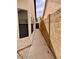 Narrow sideyard with concrete pathway and block wall, offering private outdoor access at 3932 E Tierra Buena E Ln, Phoenix, AZ 85032
