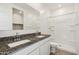 Well-lit bathroom featuring a double sink vanity and a walk-in shower at 40070 W Venture Rd, Maricopa, AZ 85138