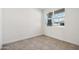 Well-lit bedroom featuring a window with views of the surrounding neighborhood at 40070 W Venture Rd, Maricopa, AZ 85138