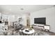 Bright living area with stylish décor, a view of the dining area, and a large television at 40070 W Venture Rd, Maricopa, AZ 85138