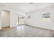 Bright living room featuring tile floors and sliding glass doors to the backyard at 40070 W Venture Rd, Maricopa, AZ 85138