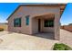 A covered patio extends from the home, with a brick-paved pad and low-maintenance landscaping at 41103 W Rio Bravo Dr, Maricopa, AZ 85138