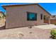 The home features low-maintenance landscaping and a covered patio accessible via large picture windows at 41103 W Rio Bravo Dr, Maricopa, AZ 85138