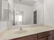 Bathroom featuring a large mirror over a vanity sink and an open doorway to other areas of the home at 41103 W Rio Bravo Dr, Maricopa, AZ 85138