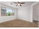 This carpeted bedroom has natural light coming in through the large window at 41103 W Rio Bravo Dr, Maricopa, AZ 85138