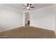 The main bedroom has neutral carpet, a ceiling fan, and an attached bathroom at 41103 W Rio Bravo Dr, Maricopa, AZ 85138