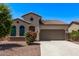 Charming single-story home with a well-manicured yard and a two-car garage, creating inviting curb appeal at 41103 W Rio Bravo Dr, Maricopa, AZ 85138