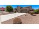 Street view of a one-story home featuring desert landscaping, concrete driveway, and an attached two-car garage at 41103 W Rio Bravo Dr, Maricopa, AZ 85138