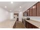 Well-equipped kitchen features an island, stainless steel appliances, and ample counter space for meal preparation at 41103 W Rio Bravo Dr, Maricopa, AZ 85138