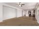 Open-concept living room flows to kitchen with island and features a ceiling fan for added comfort at 41103 W Rio Bravo Dr, Maricopa, AZ 85138