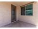 Enclosed back patio featuring a door and a window at 41103 W Rio Bravo Dr, Maricopa, AZ 85138