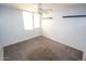 Bright bedroom with a ceiling fan, neutral carpet and white walls at 4120 N 78Th St # 116, Scottsdale, AZ 85251