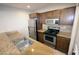Well-lit Kitchen with stainless steel appliances, neutral stone countertops, and brown wood cabinets at 4120 N 78Th St # 116, Scottsdale, AZ 85251
